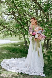 A vibrant summer wedding at The Oaks in Colorado featuring Alena Leena bridal and bold florals by Eleven Blooms Floral.