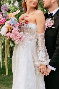 A vibrant summer wedding at The Oaks in Colorado featuring Alena Leena bridal and bold florals by Eleven Blooms Floral.