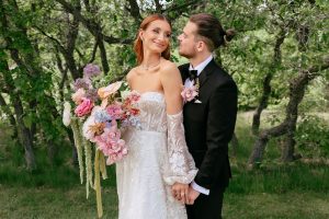A vibrant summer wedding at The Oaks in Colorado featuring Alena Leena bridal and bold florals by Eleven Blooms Floral.