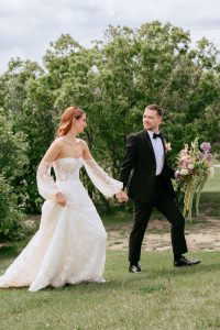 A vibrant summer wedding at The Oaks in Colorado featuring Alena Leena bridal and bold florals by Eleven Blooms Floral.