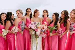 A vibrant summer wedding at The Oaks in Colorado featuring Alena Leena bridal and bold florals by Eleven Blooms Floral.