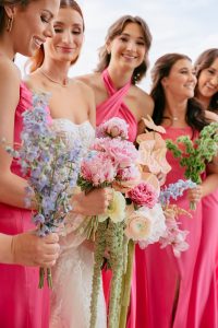 A vibrant summer wedding at The Oaks in Colorado featuring Alena Leena bridal and bold florals by Eleven Blooms Floral.