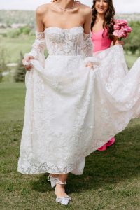 A vibrant summer wedding at The Oaks in Colorado featuring Alena Leena bridal and bold florals by Eleven Blooms Floral.