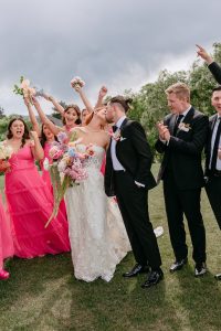 A vibrant summer wedding at The Oaks in Colorado featuring Alena Leena bridal and bold florals by Eleven Blooms Floral.