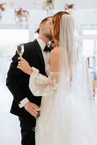 A vibrant summer wedding at The Oaks in Colorado featuring Alena Leena bridal and bold florals by Eleven Blooms Floral.
