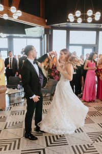A vibrant summer wedding at The Oaks in Colorado featuring Alena Leena bridal and bold florals by Eleven Blooms Floral.