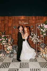 A vibrant summer wedding at The Oaks in Colorado featuring Alena Leena bridal and bold florals by Eleven Blooms Floral.
