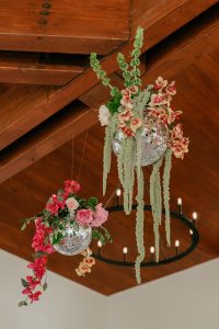 A vibrant summer wedding at The Oaks in Colorado featuring Alena Leena bridal and bold florals by Eleven Blooms Floral.