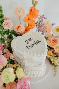 A vibrant summer wedding at The Oaks in Colorado featuring Alena Leena bridal and bold florals by Eleven Blooms Floral.