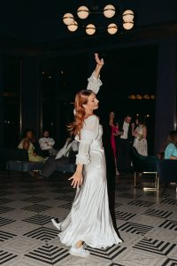A vibrant summer wedding at The Oaks in Colorado featuring Alena Leena bridal and bold florals by Eleven Blooms Floral.